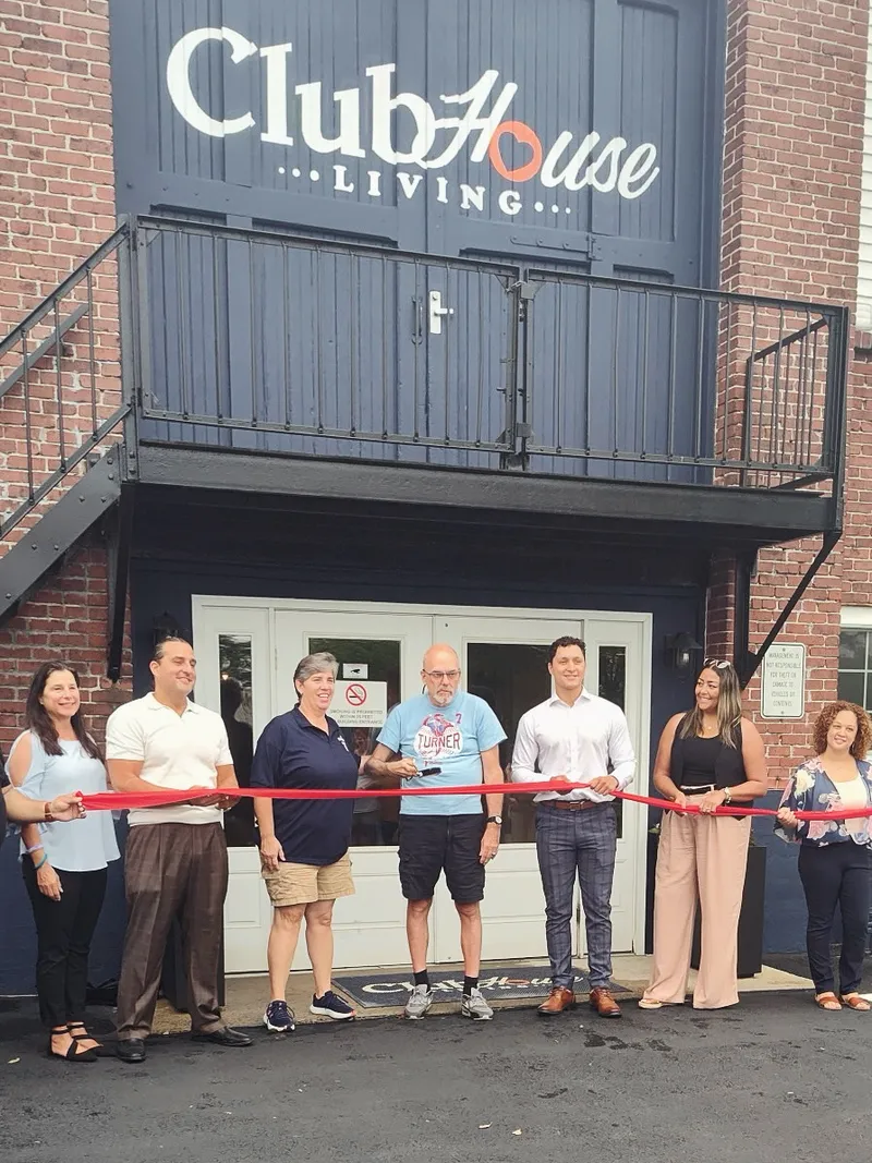 Community leaders cut the red ribbon at Clubhouse Living's grand opening